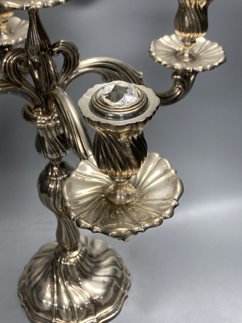 An early 20th century continental 830 white metal four branch, five light candelabrum,